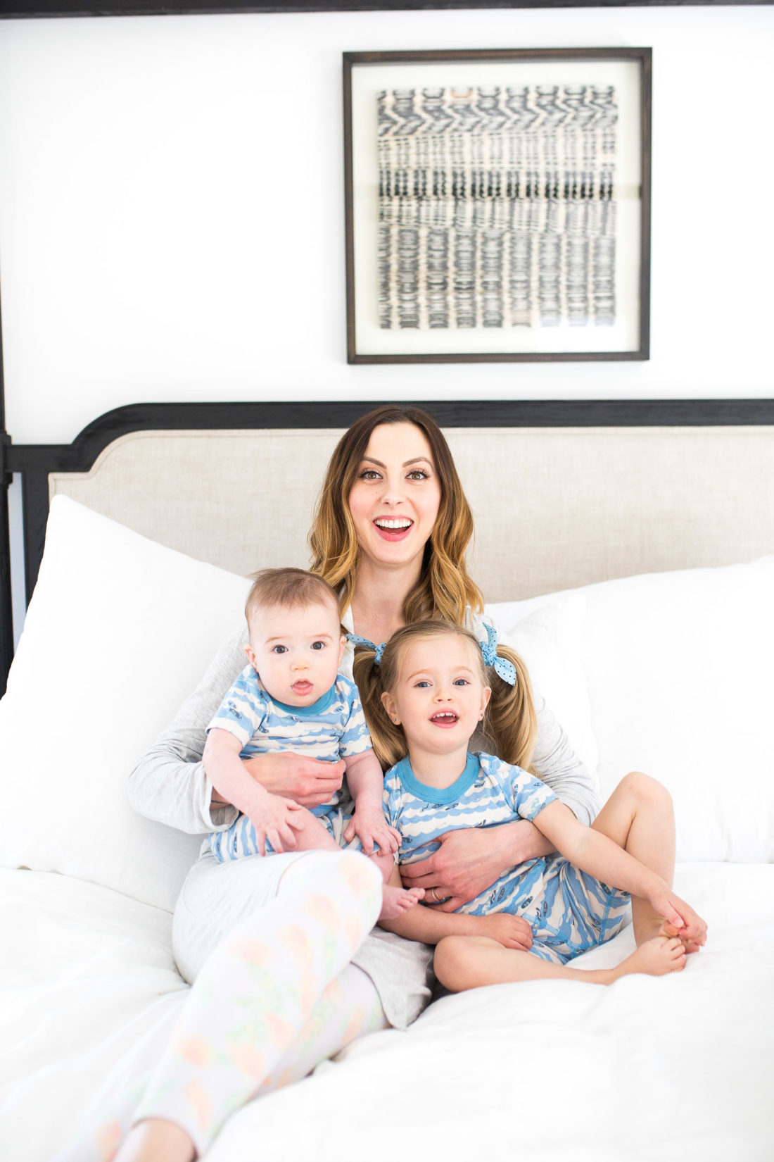 Eva Amurri Martino sits in bed with her two children wearing matching pajamas