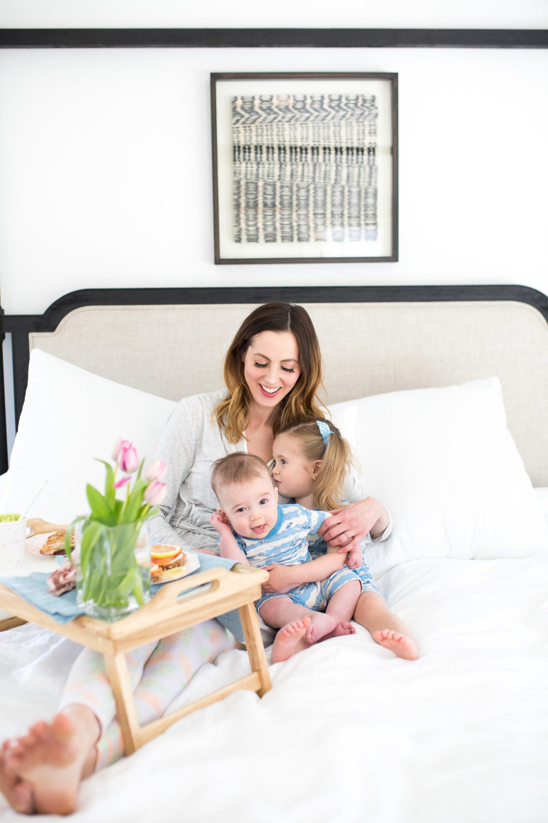 EVa Amurri Martino balances her two children on her lap while eating a yummy Mother's Day breakfast in bed