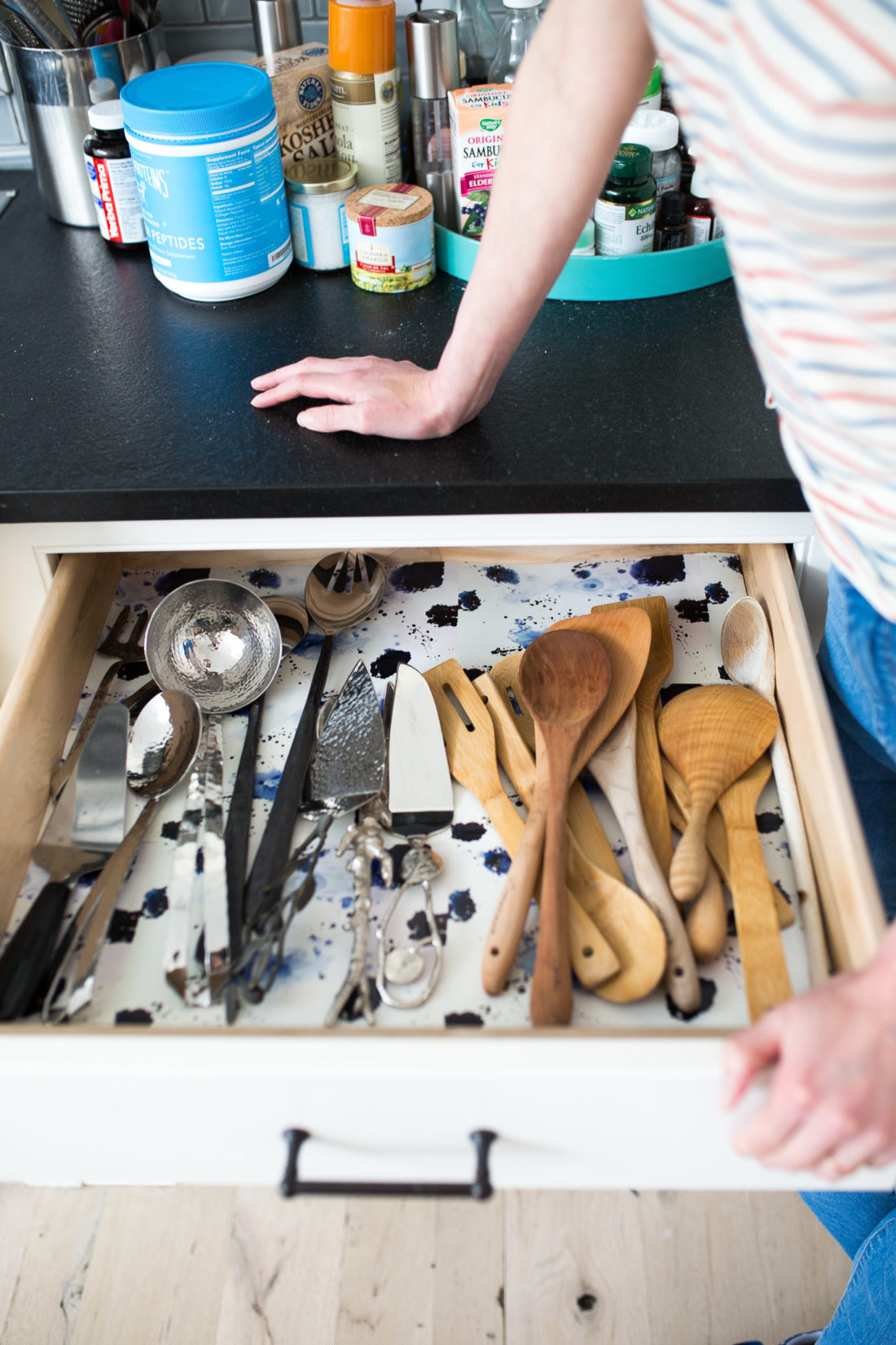 A wallpaper-lined serving implement drawer in Eva Amurri Martino's Connecticut kitchen