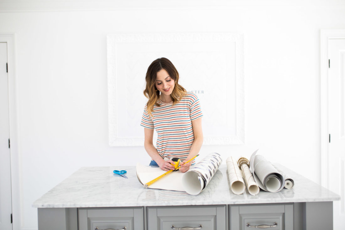 Eva Amurri Martino measures and cuts leftover wallpaper to use in other projects