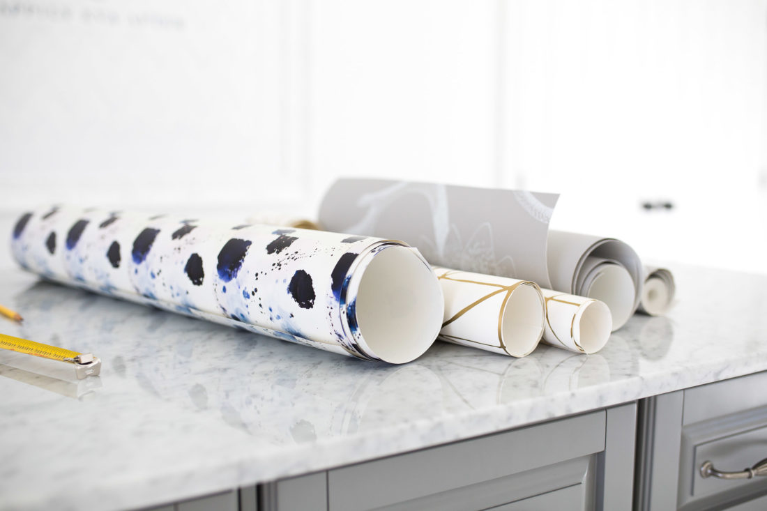 Extra rolls of wallpaper are laid out on Eva Amurri Martino's studio island. 