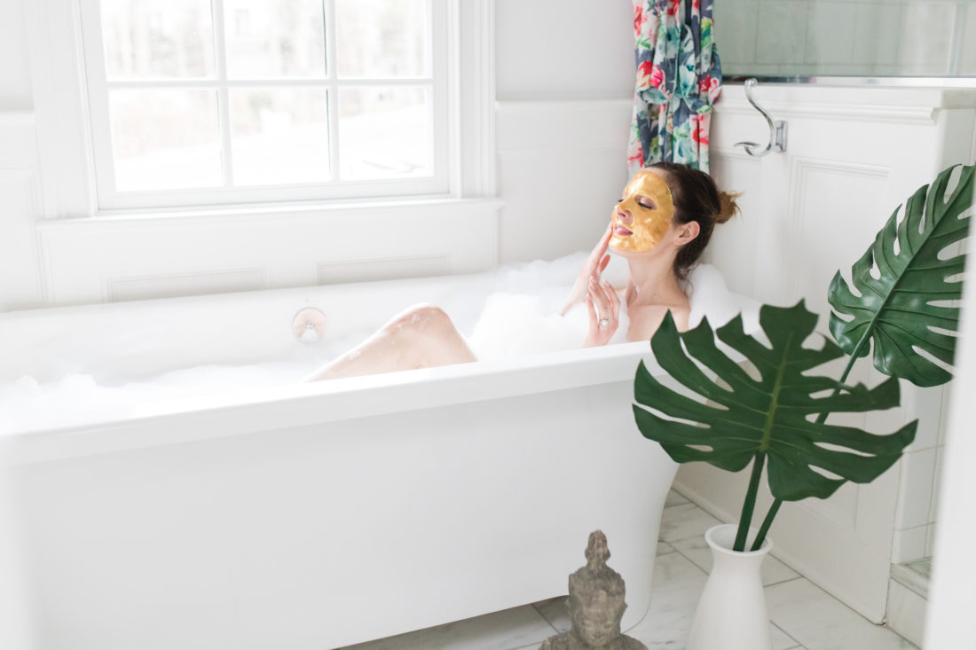 Eva Amurri Martino relaxes in the bath with a gold sheet mask on her face