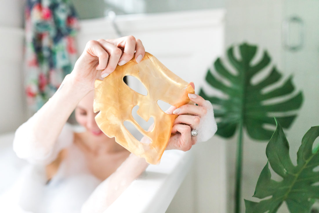 Eva Amurri Martino holds up a 24 karat gold sheet mask