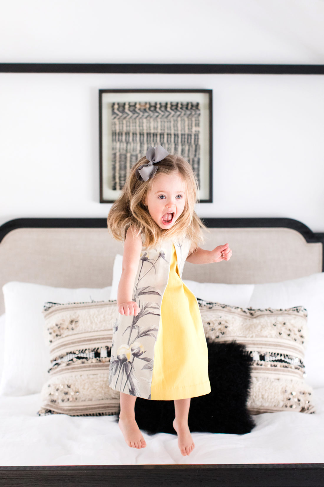 Marlowe Martino jumps happily on her mother's bed