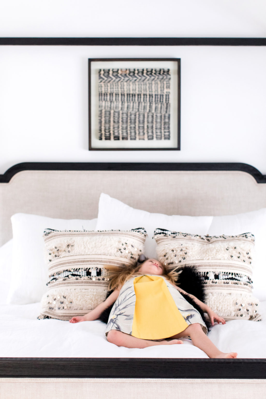 Marlowe Martino lays back on her Mom's black and white patterned bed pillows