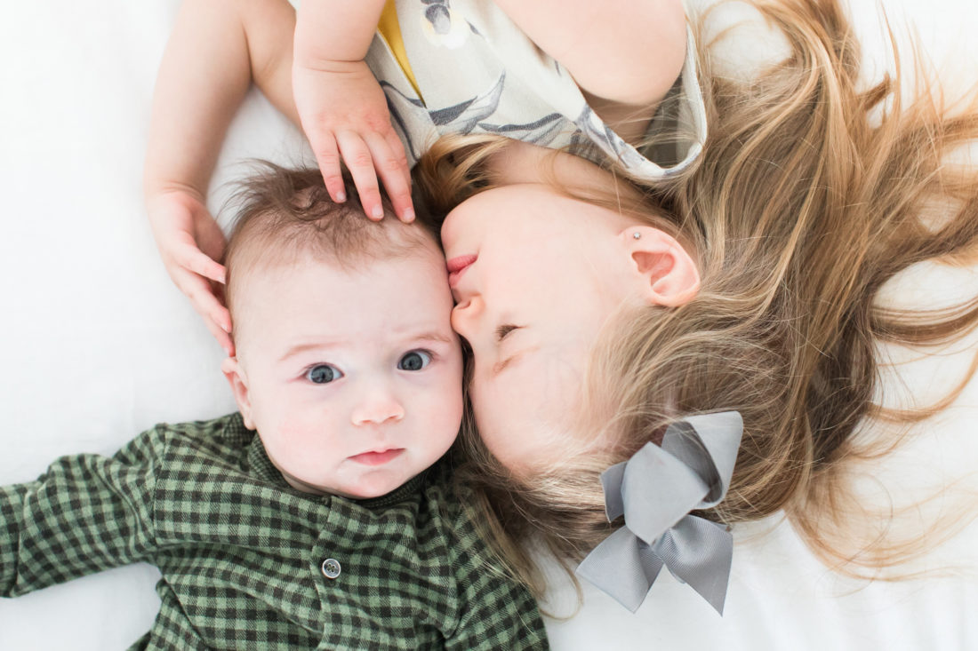 Marlowe Martino holds her baby brother and gives him a sweet kiss on the head