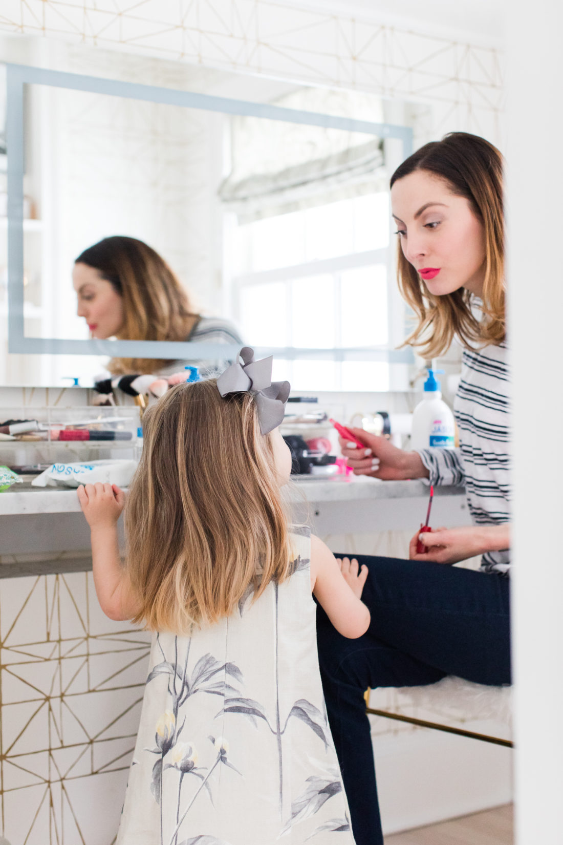 Eva Amurri martino applies makeup in her Glam Room while two year old daughter Marlowe looks on