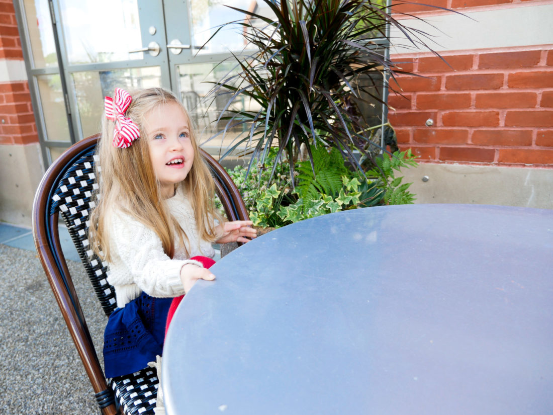 Marlowe Martino sits at an outdoor table in Westport Connecticut to eat breakfast