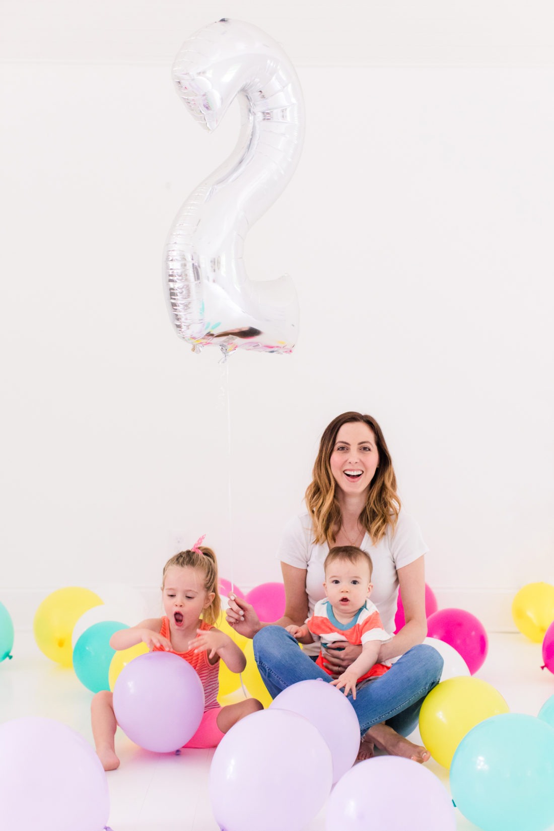 Eva Amurri Martino sits with children Marlowe and Major among tons of multicolored balloons to celebrate the Happily Eva After two year anniversary