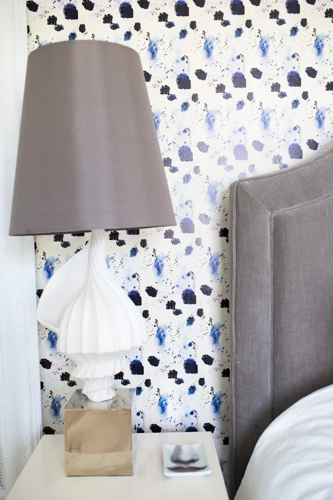 A detail of the bedside table and fun wallpaper in the guest room of Eva Amurri Martino's connecticut home