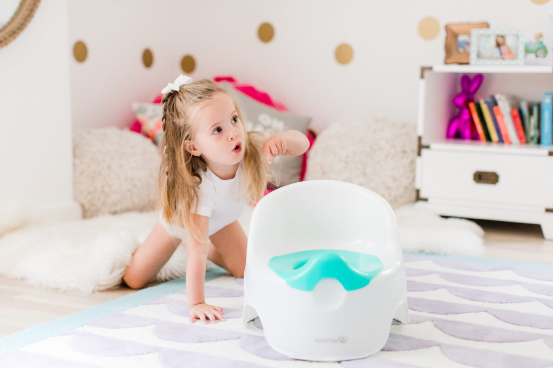 Marlowe Martino shows off her potty chair in her bedroom