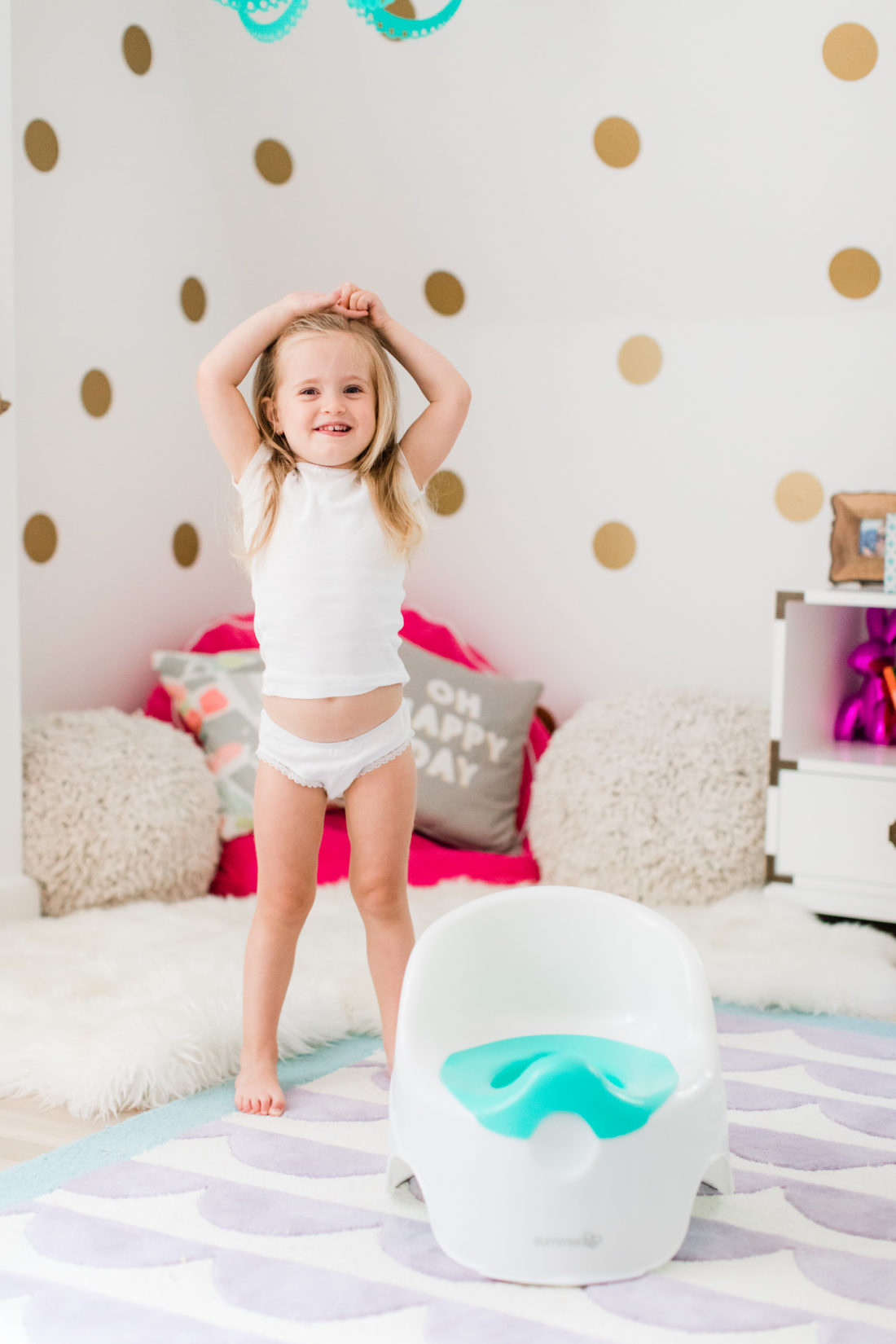 Marlowe Martino is pictured in her bedroom with her potty chair