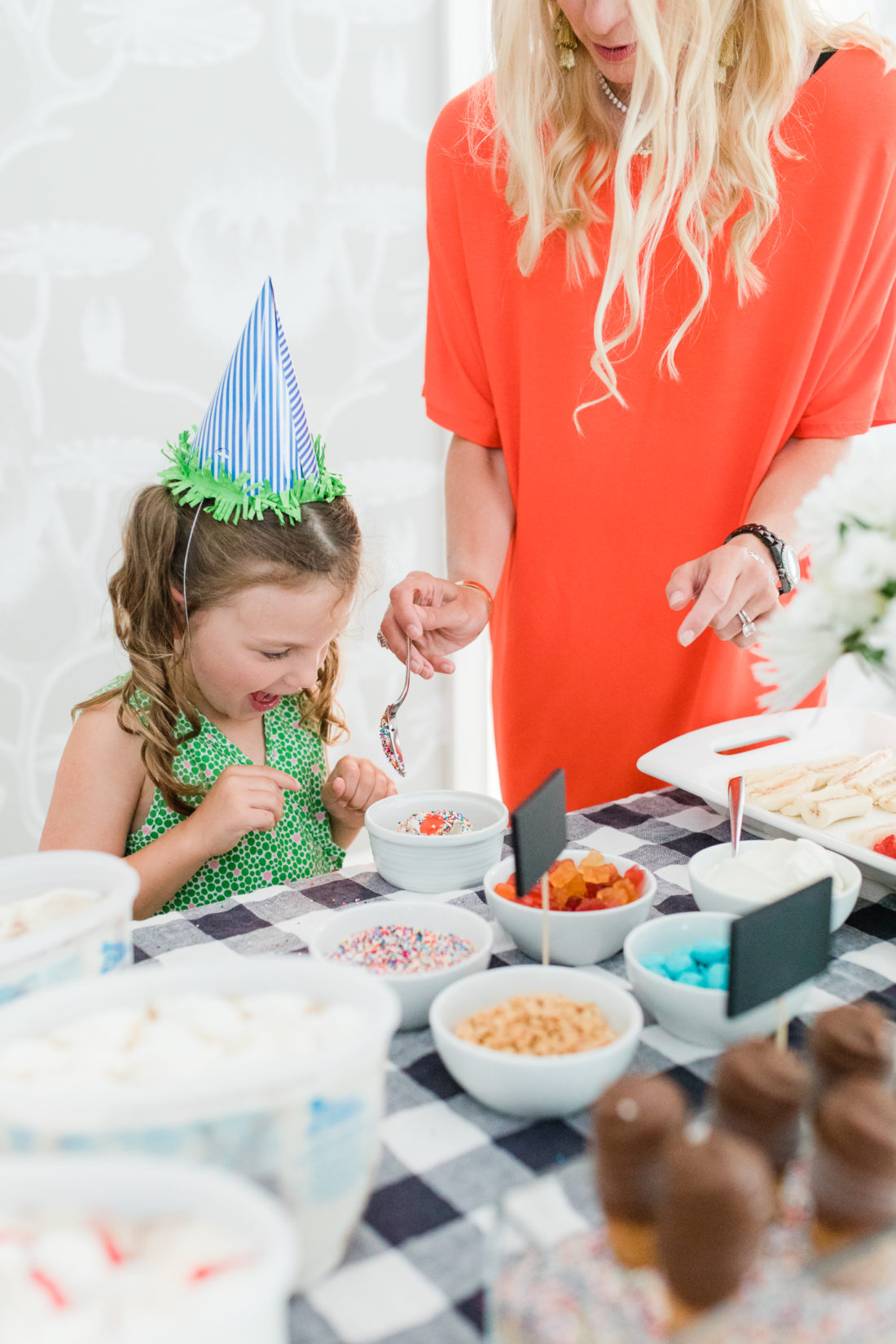 Morgan Hutchinson and daughter Olive Bee make sundaes at the Happily Eva After ice cream social