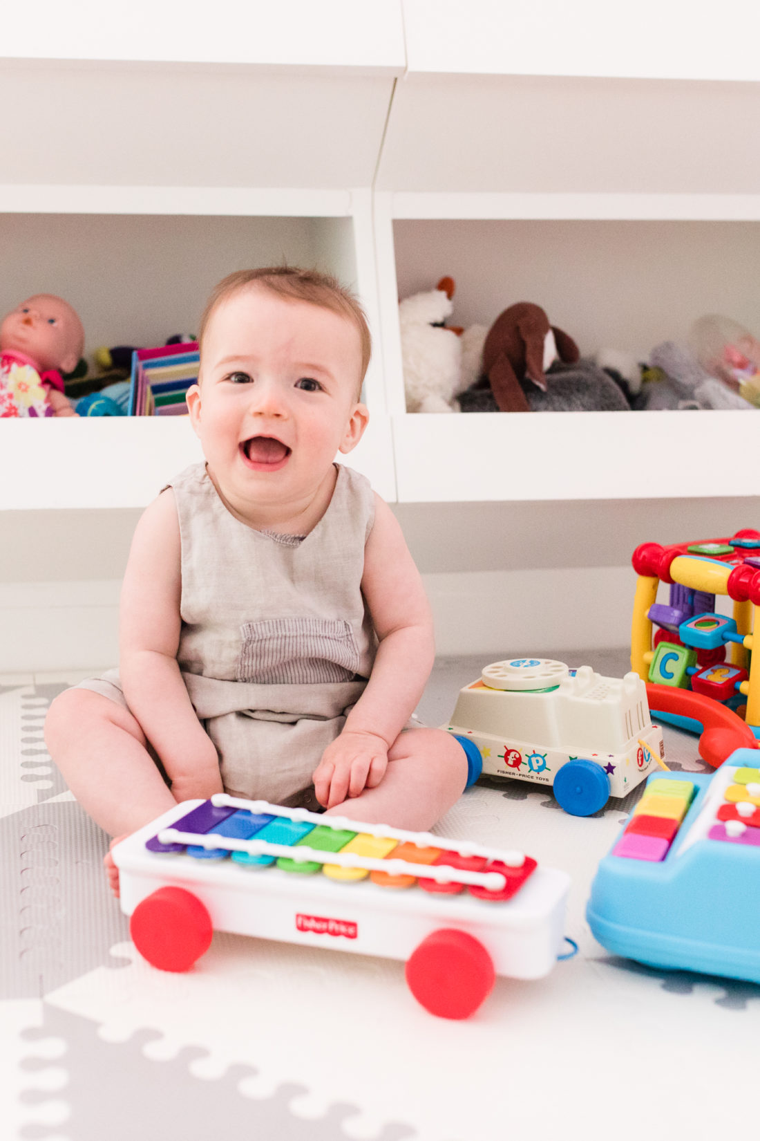 Eight month old Major Martino sits among his colorful toys at home in Connecticut