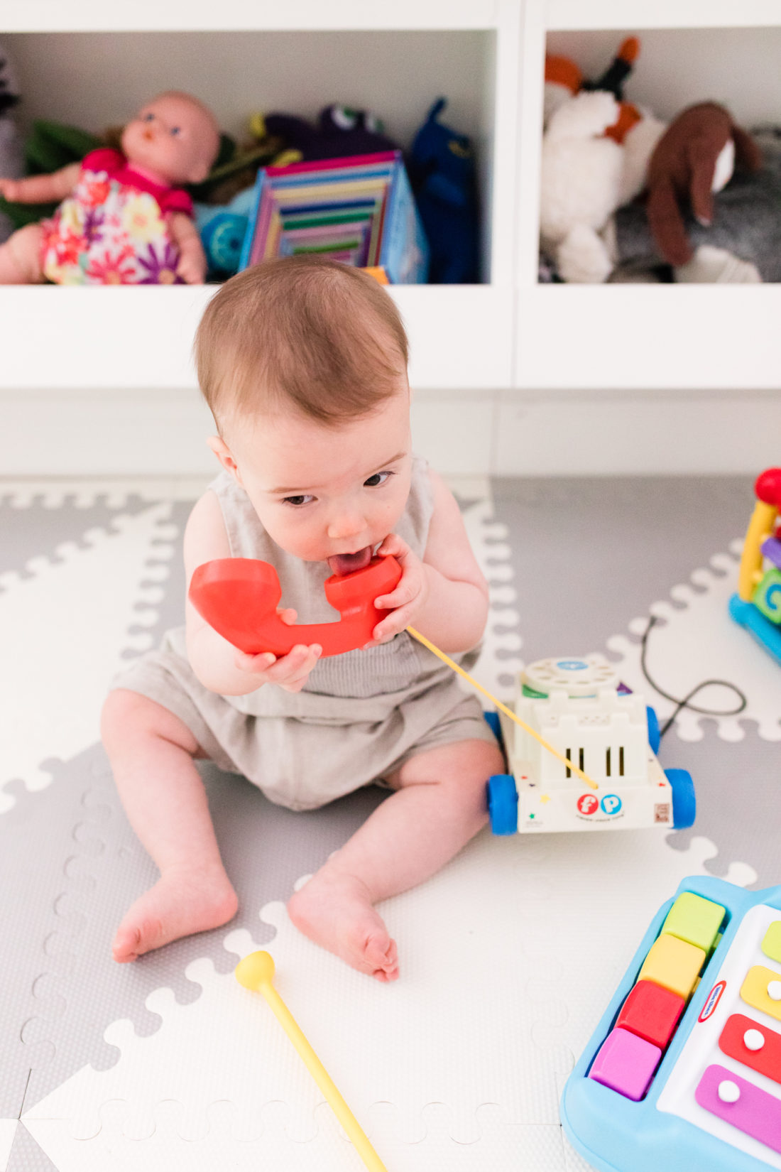 Eight month old Major Martino sits among his colorful toys at home in Connecticut