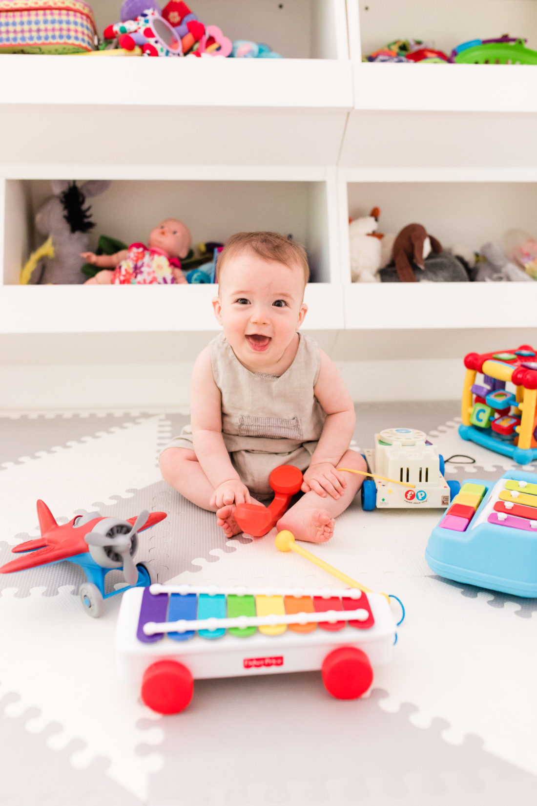 Eight month old Major Martino sits among his colorful toys at home in Connecticut