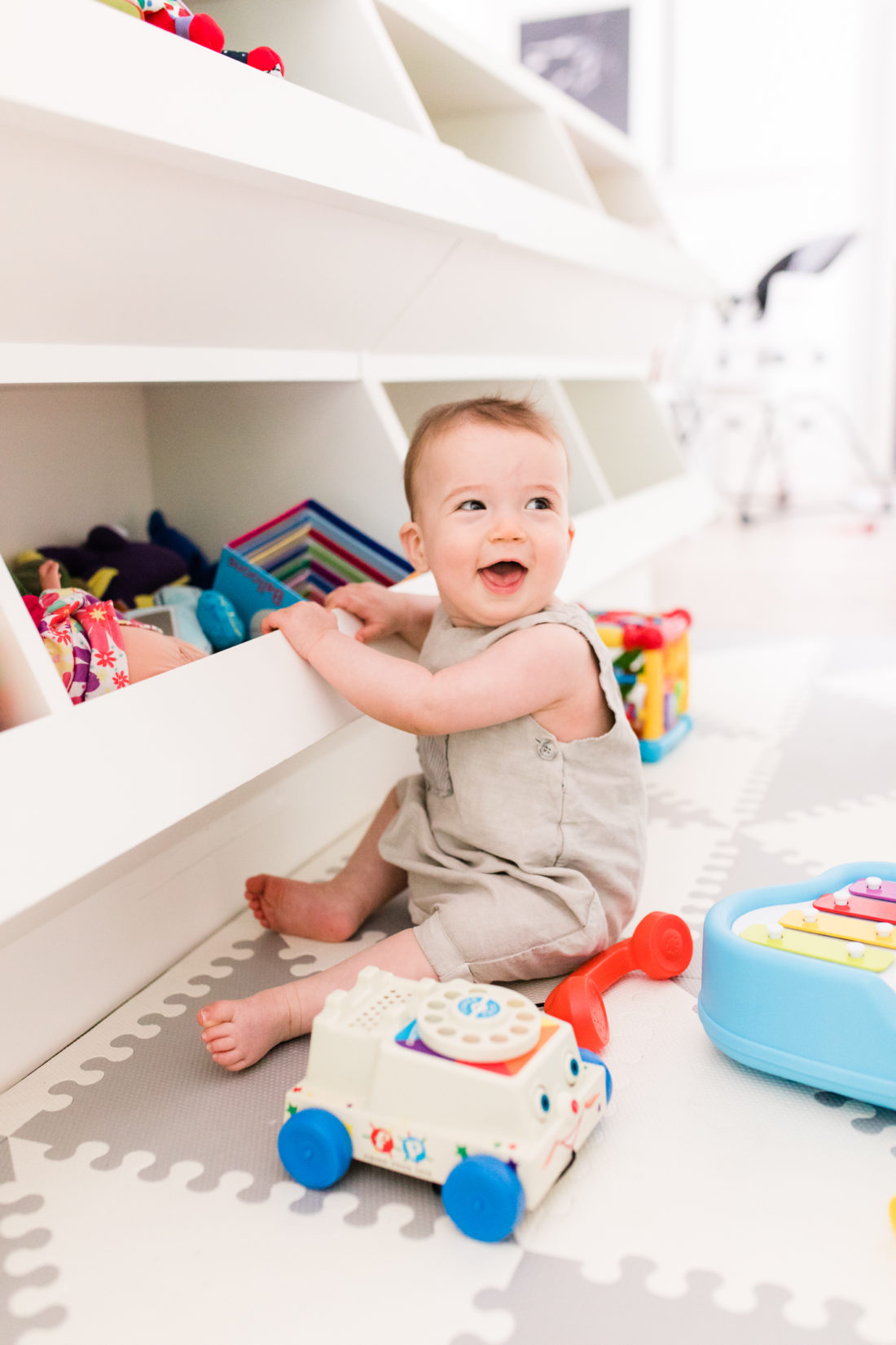 Eight month old Major Martino sits among his colorful toys at home in Connecticut