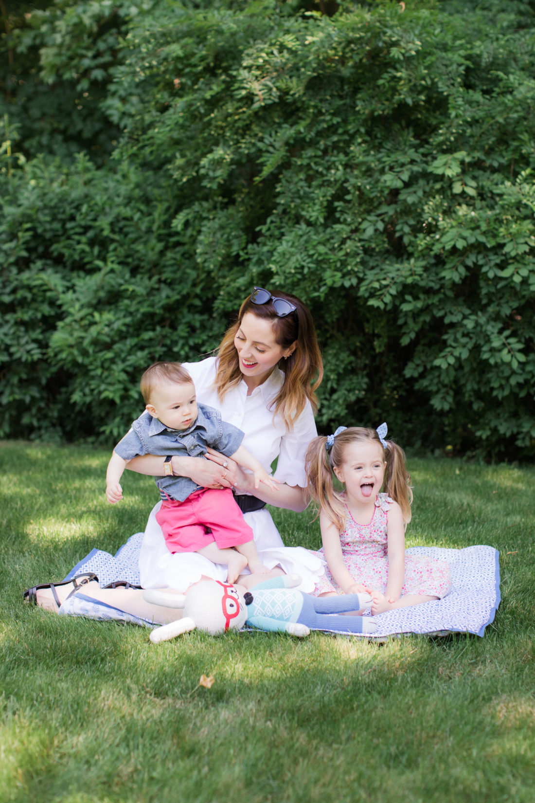 Eva Amurri Martino of lifestyle and motherhood blog Happily Eva After relaxes on a picnic blanket with her two children Marlowe and Major