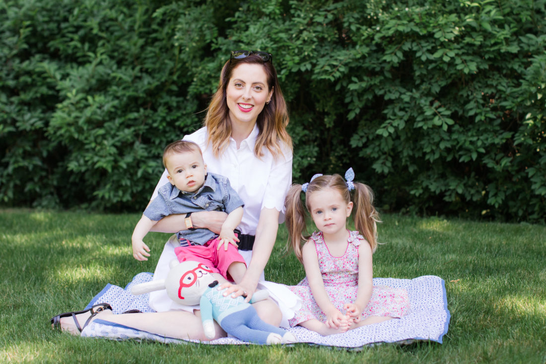 Eva Amurri Martino of lifestyle and motherhood blog Happily Eva After relaxes on a picnic blanket with her two children Marlowe and Major