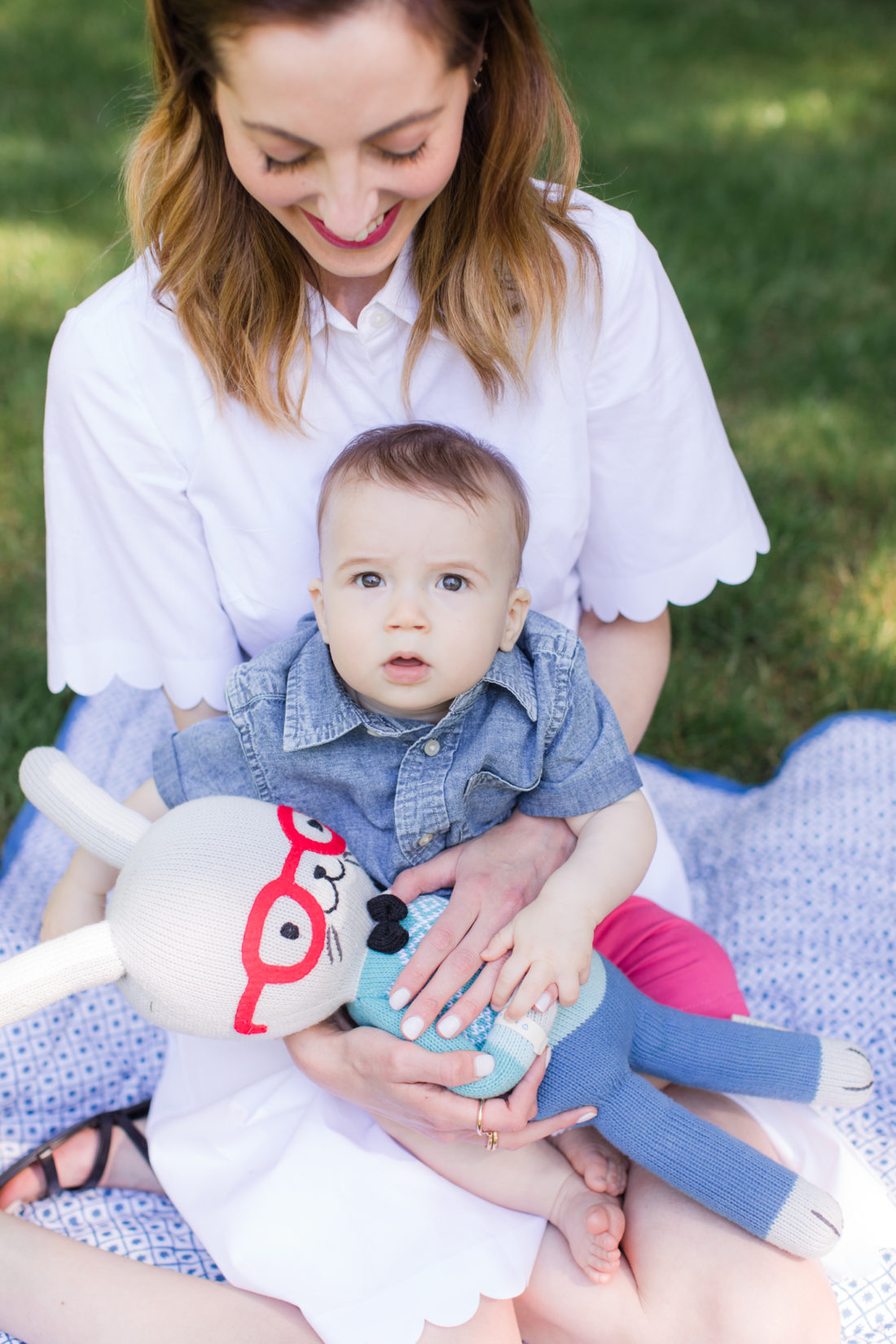 Eva Amurri Martino of lifestyle and motherhood blog Happily Eva After relaxes on a picnic blanket with her two children Marlowe and Major