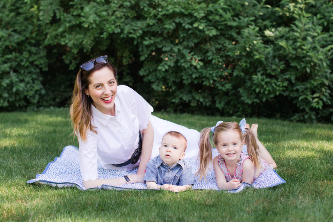 Eva Amurri Martino of lifestyle and motherhood blog Happily Eva After relaxes on a picnic blanket with her two children Marlowe and Major
