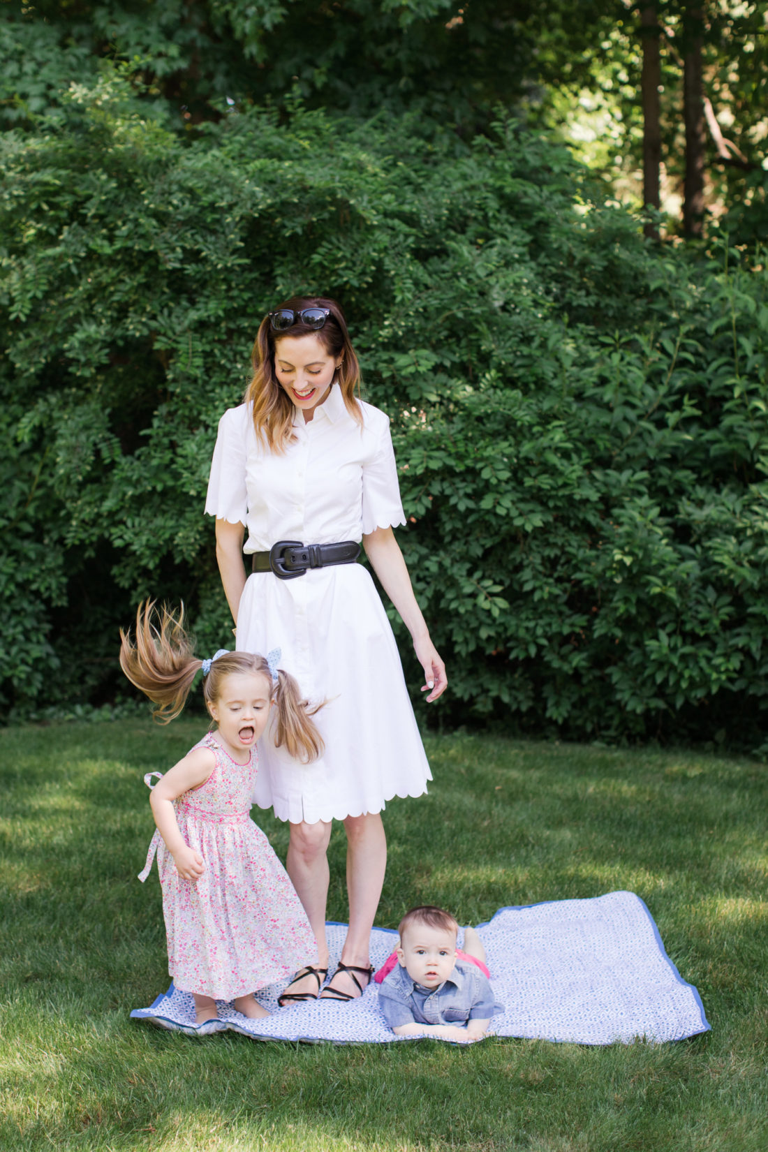 Eva Amurri Martino of lifestyle and motherhood blog Happily Eva After relaxes on a picnic blanket with her two children Marlowe and Major