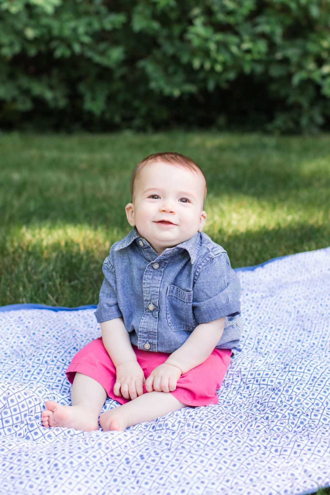 Major Martino sits on a picnic blanket on the grass outside his connecticut home