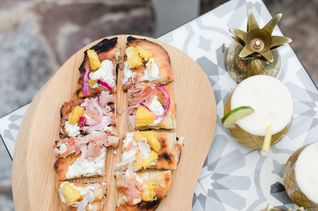 Eva Amurri Martino serves a grilled Hawaiian pizza at her Pineapple themed Happy Hour at her Connecticut home