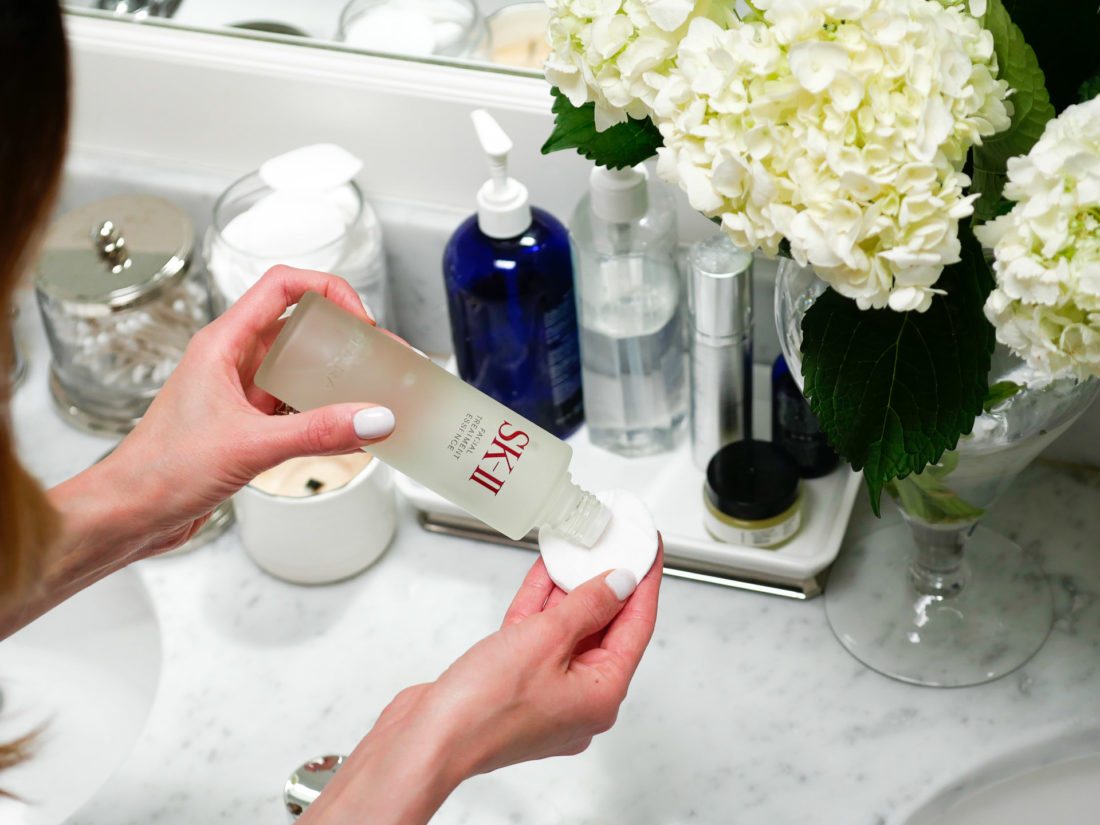 Eva Amurri Martino shakes some facial treatment essence on to a cotton pad before applying