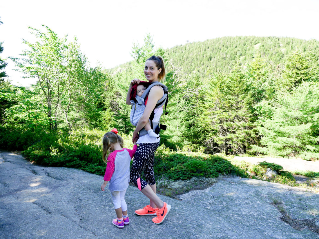 Eva Amurri Martino holds Major Martino in a baby carrier, and holds Marlowe Martino's hand on a hike in Acadia National Park