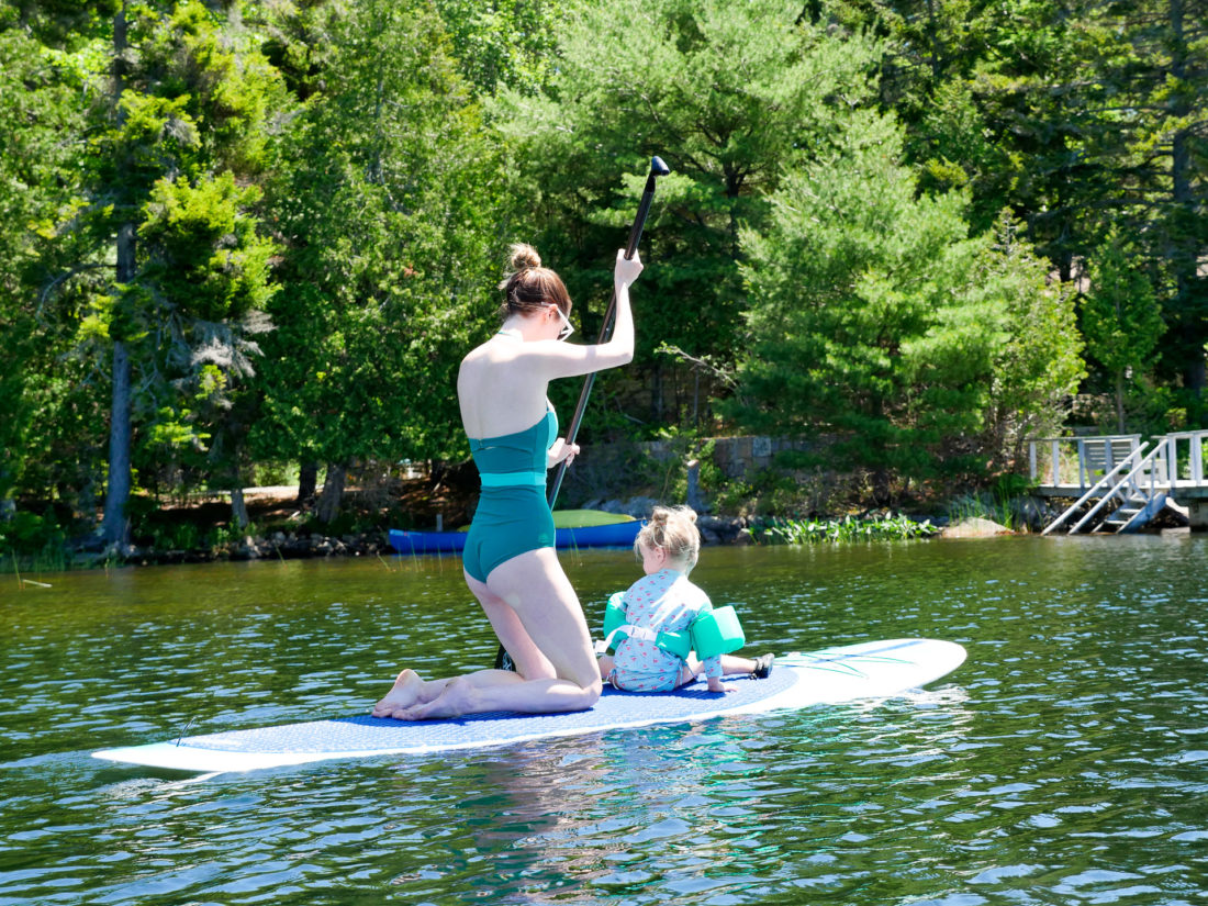 Eva Amurri Martino paddles out on the lake with Marlowe on her paddle board