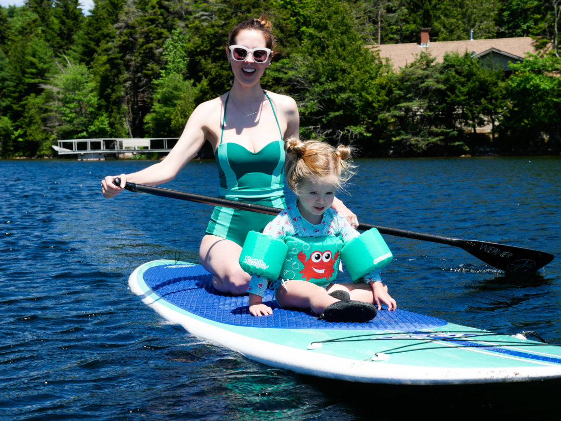 Eva Amurri Martino paddles out on the lake with Marlowe on her paddle board