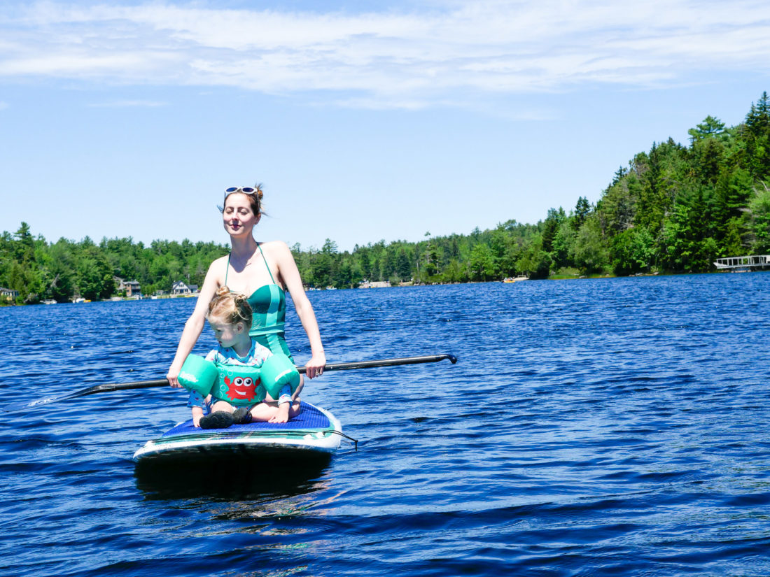 Eva Amurri Martino paddles out on the lake with Marlowe on her paddle board