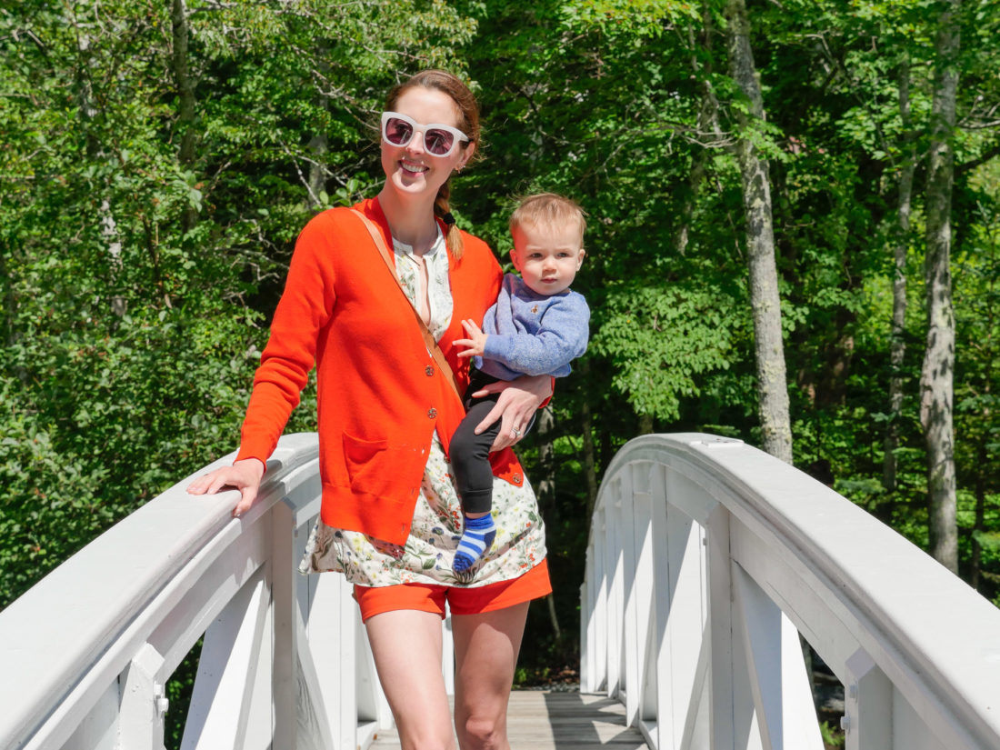 Eva Amurri Martino crosses a scenic bridge in Bar Harbor Maine, with 9 month old son Major on her hip