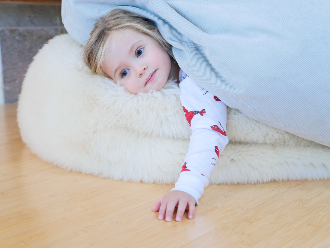 Marlowe Martino lays on a bean bag wearing Lobster pajamas