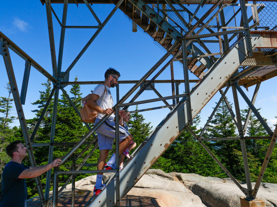 Kyle Martino hikes with two year old daughter Marlowe on a trail in Acadia National Park