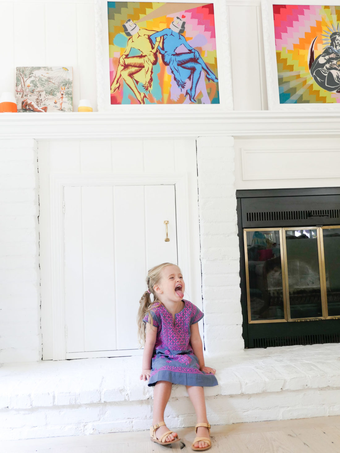 Marlowe Martino sticks her tongue out on the hearth of the fireplace in the family room of her Connecticut home