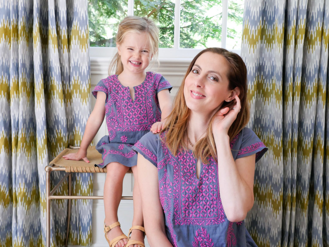 Eva Amurri Martino and Marlowe Martino wear matching embroidered dresses and sit together in the living room of their Connecticut home