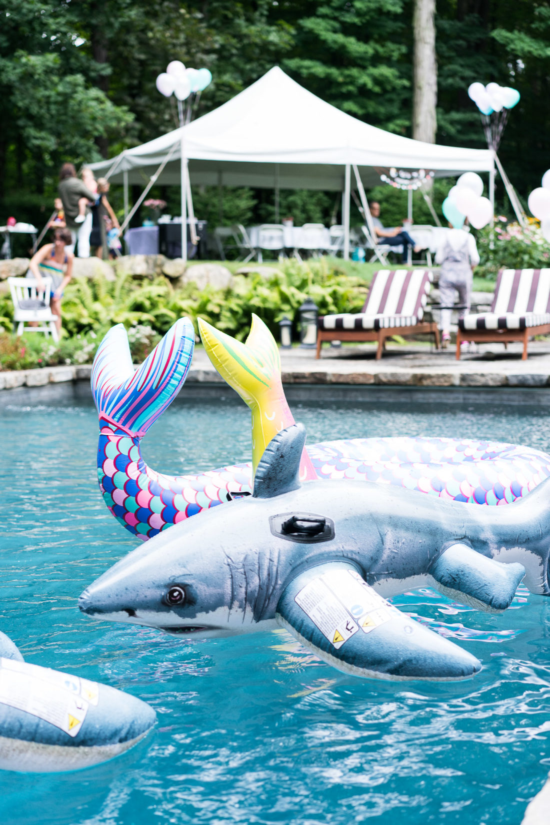 Mermaid and shark floats fill the pool at Marlowe Martino's third birthday party