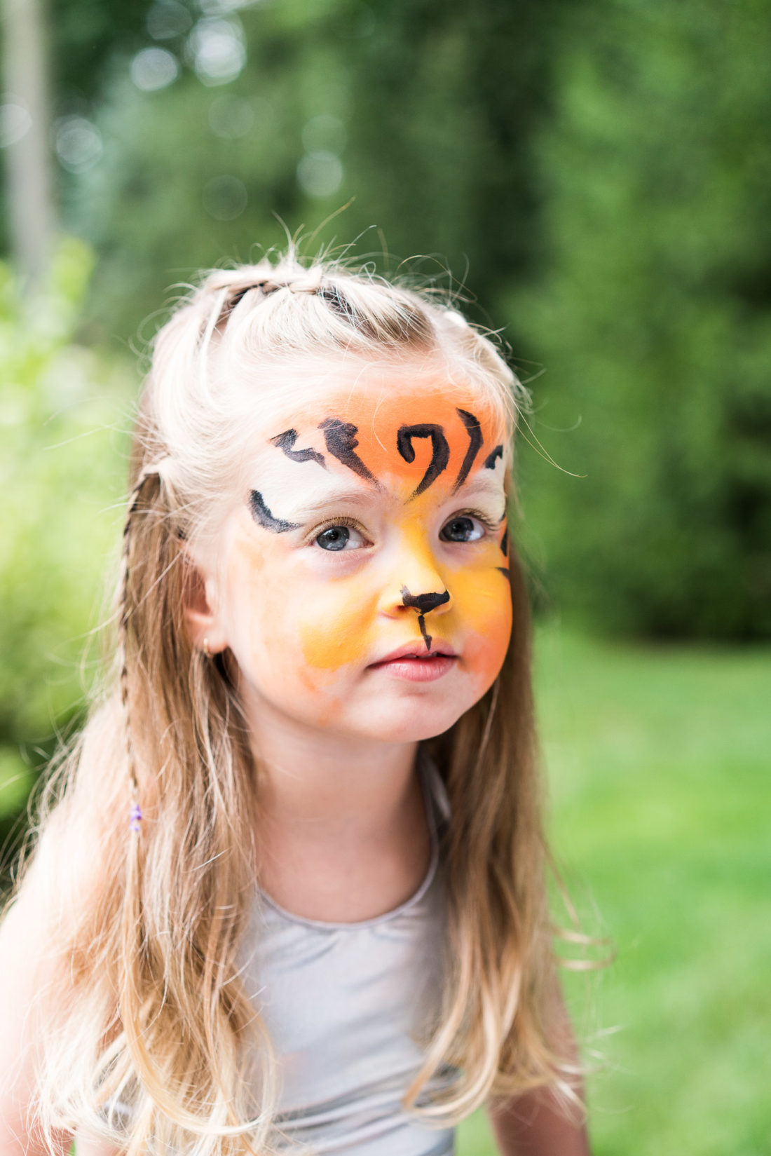 Marlowe Martino gets her face painted like a tiger at her third birthday party