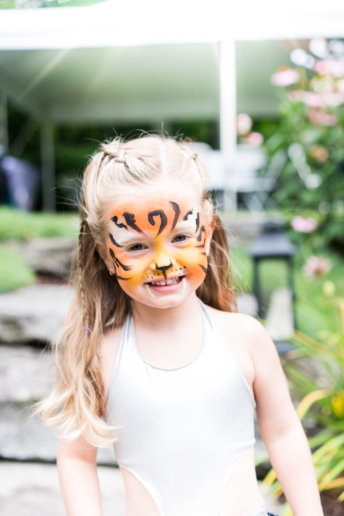 Marlowe Martino gets her face painted like a tiger at her third birthday party