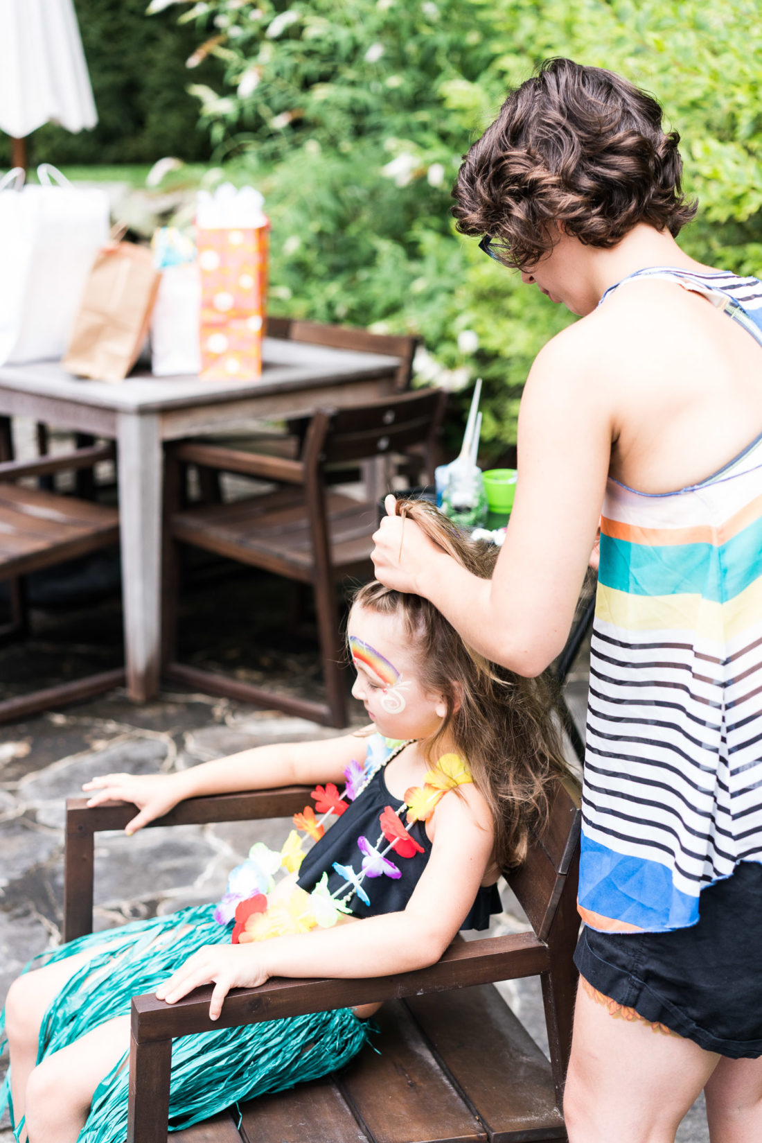 A party guest gets her hair braided at Marlowe Martino's third birthday party