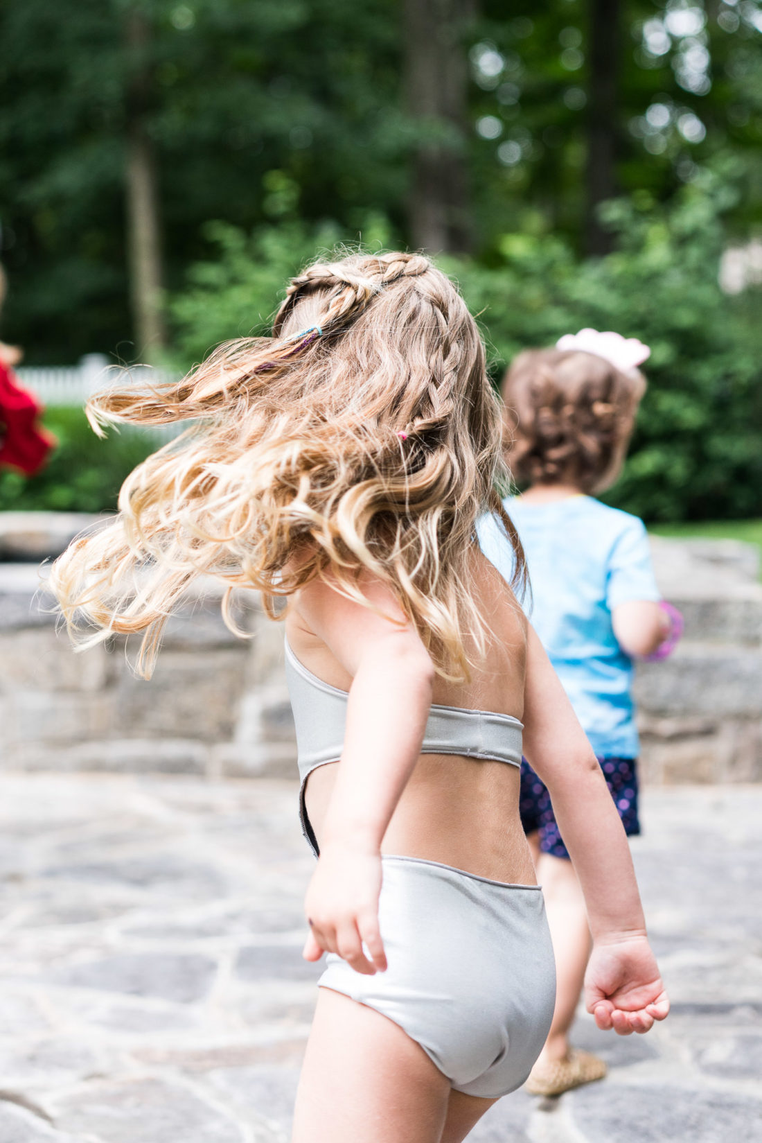 Marlowe Martino runs around at her third birthday party wearing a silver monokini bathing suit