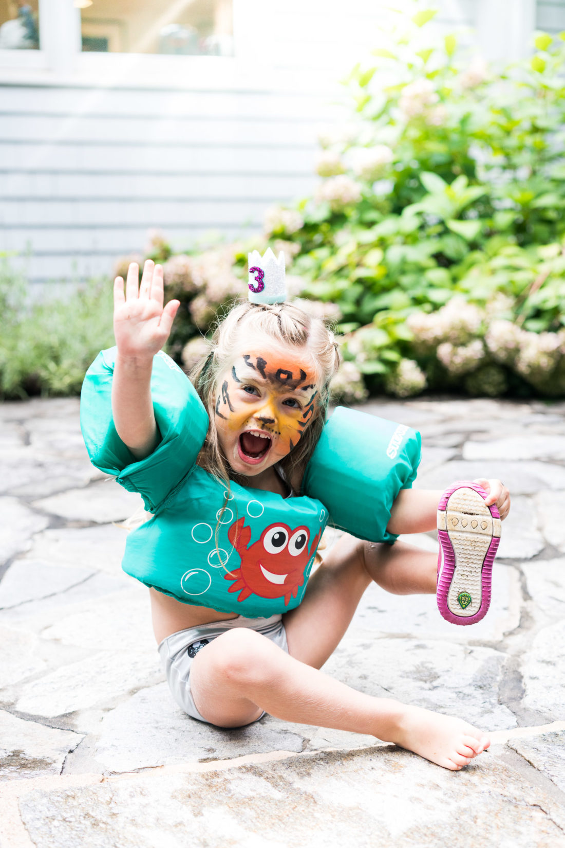 Marlowe Martino wears a birthday crown and tiger face paint at her third birthday party