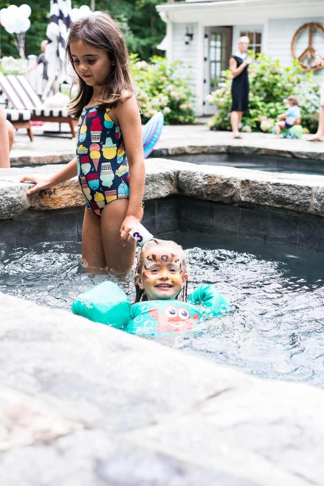 Marlowe Martino swims with friends in the hot tub at her third birthday party