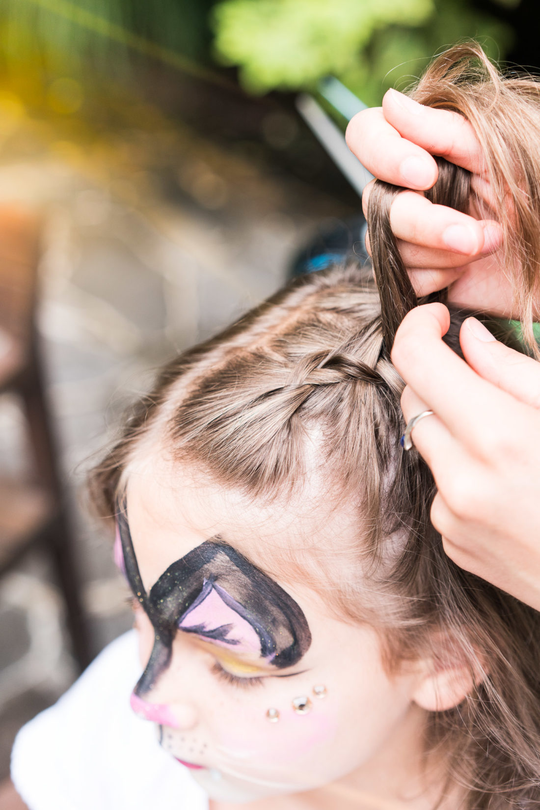 Guests get their hair braided at Marlowe Martino's third birthday party