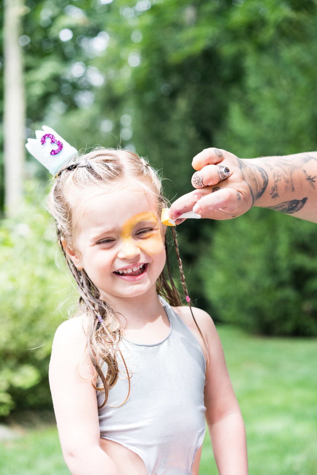 Marlowe Martino gets her face painted for a second time at her third birthday party