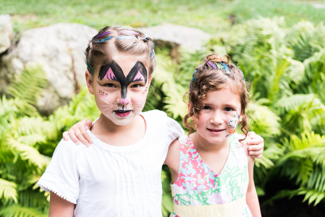 Marlowe Martino gets her face painted like a tiger at her third birthday party