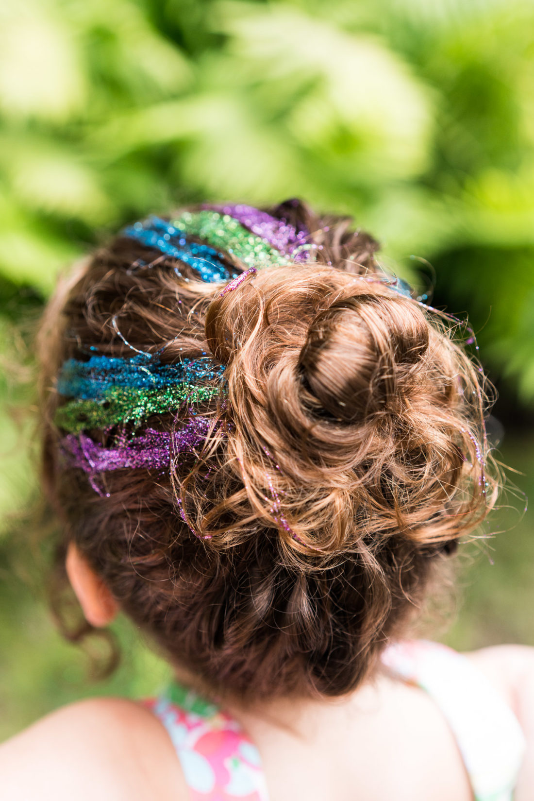 Party guests get glitter in their hair at the mermaid braid bar at Marlowe Martino's third birthday party