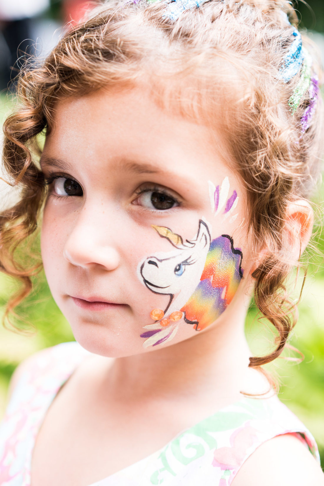 Marlowe Martino gets her face painted like a tiger at her third birthday party